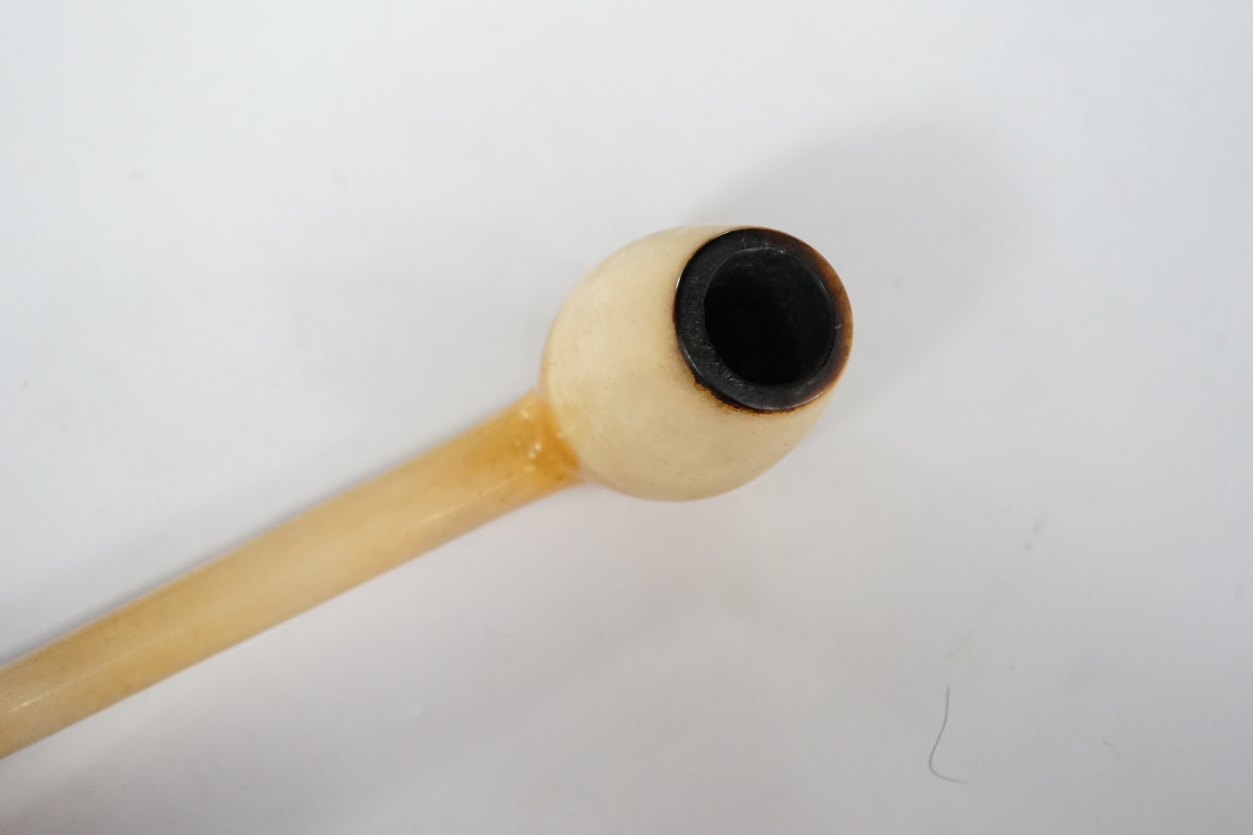 A cased and stamped Vienna Exhibition 1873 composite bowled pipe and amber mouthpiece, 26cm long
